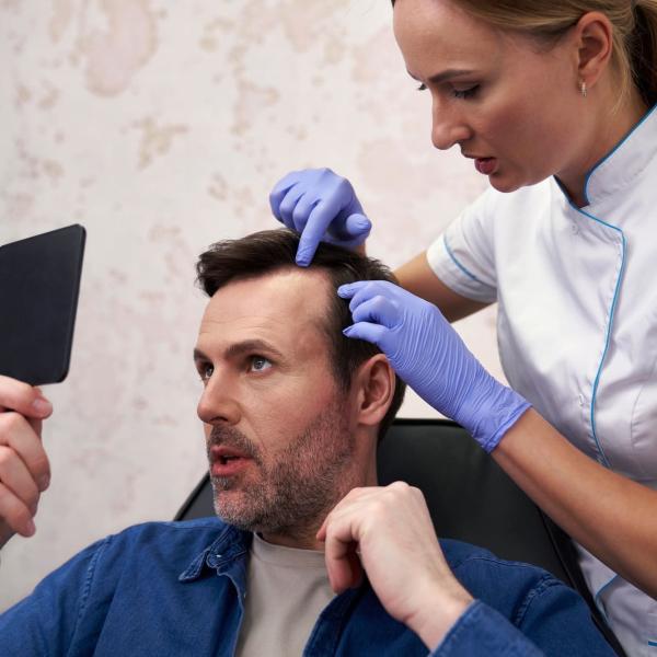 Man with baldness problem at the doctor